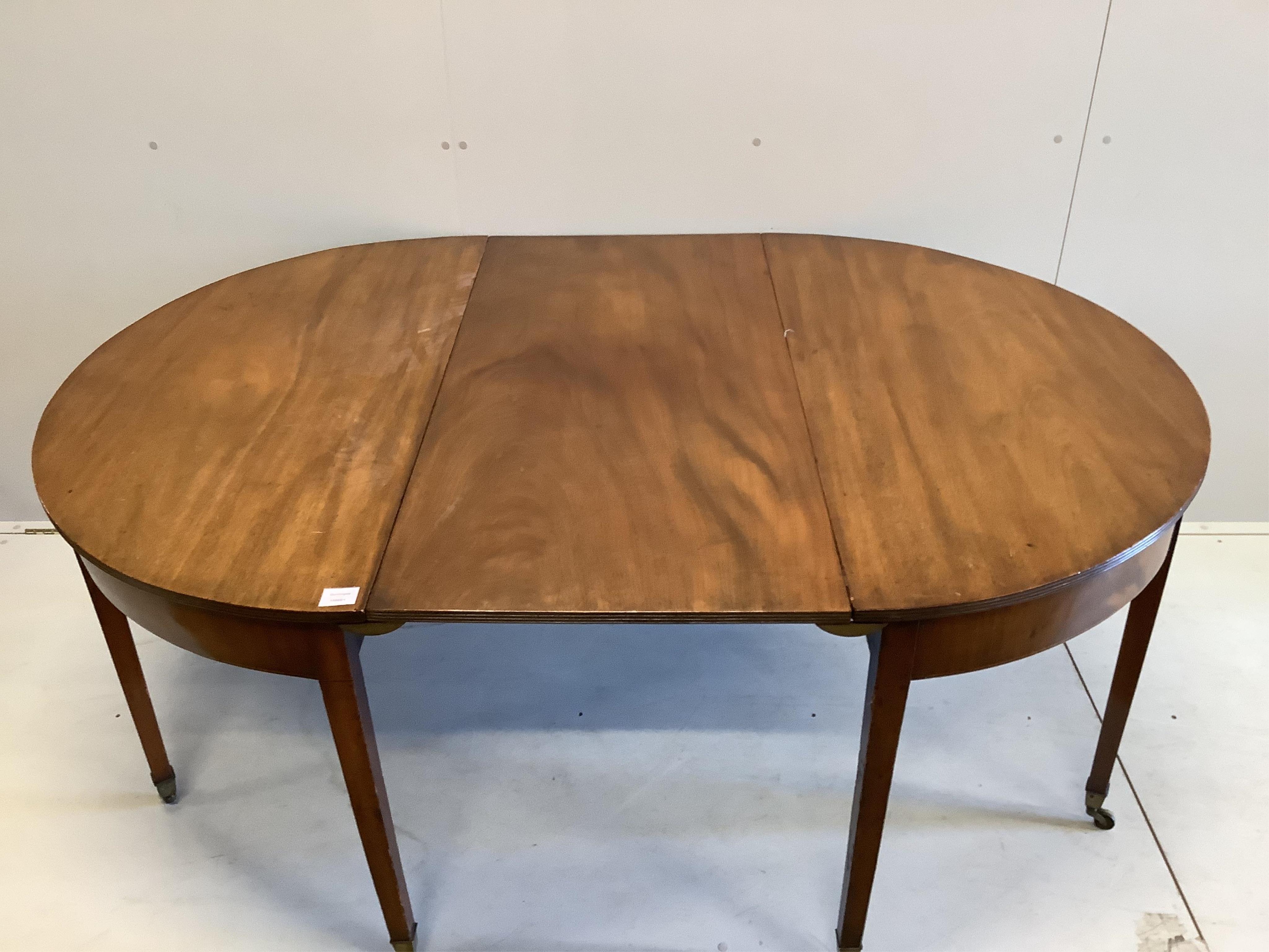 A George III mahogany D end dining table, with one leaf, width 122cm, extends to 175cm, height 70cm. Condition - a little faded otherwise fair to good condition